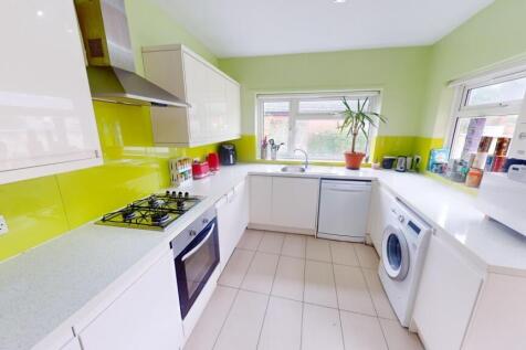 Bright and modern kitchen featuring fresh green...