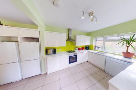 A bright and modern kitchen featuring ample nat...