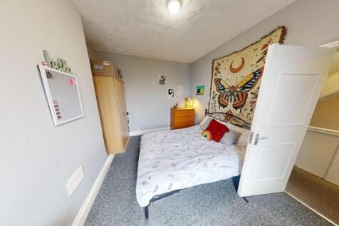 Bright and cozy double bedroom featuring a comf...