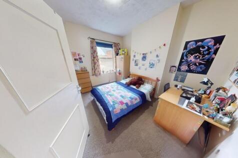 Bright and cozy single bedroom featuring a comf...