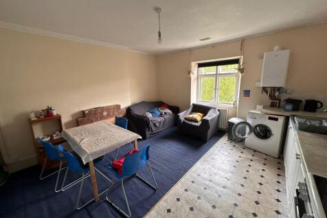 A cozy living room featuring a small seating ar...