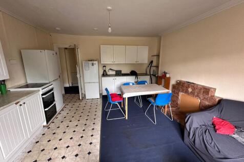A functional kitchen and dining area featuring ...