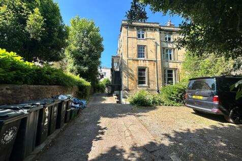 A charming front view of a classic stone terrac...