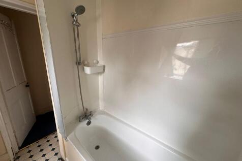 A clean and functional bathroom suite featuring...