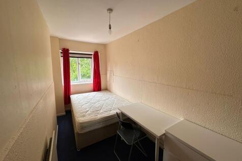 A compact single bedroom featuring a double bed...