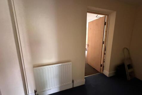 A clean and simple hallway with a white radiato...