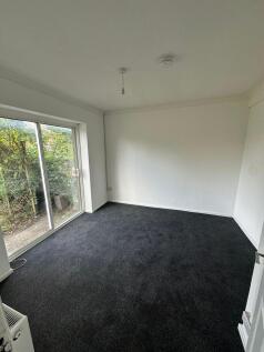 Bright and spacious bedroom featuring large sli...