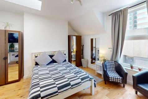 Bright and welcoming double bedroom featuring a...