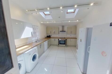 A spacious and modern kitchen with abundant nat...