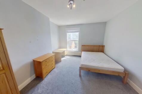 A spacious and bright double bedroom with natur...