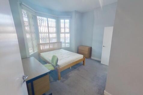A spacious and bright double bedroom with large...