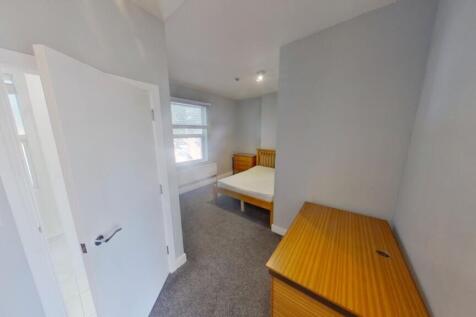 A spacious and inviting double bedroom with amp...