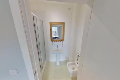 A modern and clean bathroom featuring a shower ...