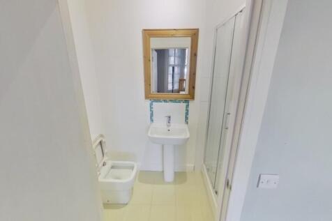 A modern and tidy bathroom featuring a clean de...