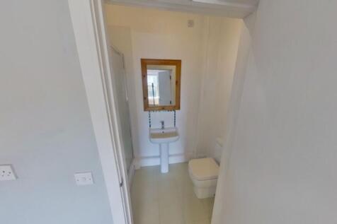 A clean and tidy bathroom featuring a modern si...