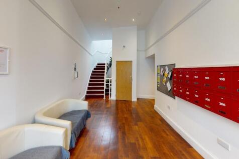 A bright, well-maintained hallway featuring pol...