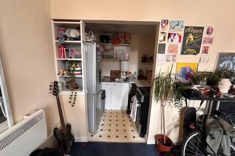 Cozy compact kitchen area integrated within a l...