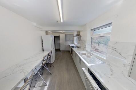 Bright, modern galley kitchen featuring sleek w...