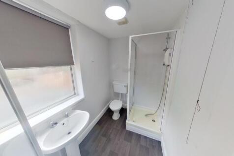 Bright and clean bathroom featuring a modern sh...
