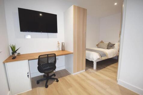 This inviting double bedroom features a cozy be...