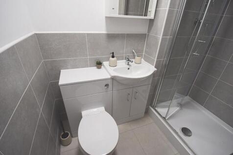 A modern bathroom featuring sleek tiles and a s...
