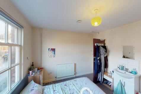 A bright and cozy double bedroom featuring a la...