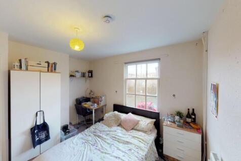 Bright and cozy double bedroom featuring a larg...