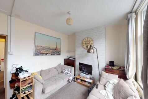 A cozy living room featuring comfortable sofas,...