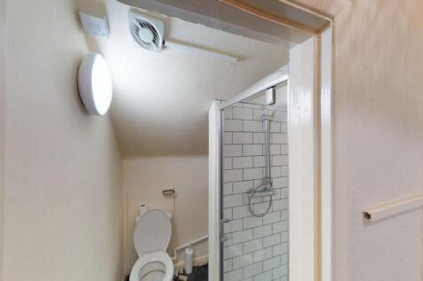 Bright and clean bathroom featuring a modern gl...