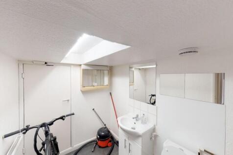 A compact, clean bathroom featuring a white sin...