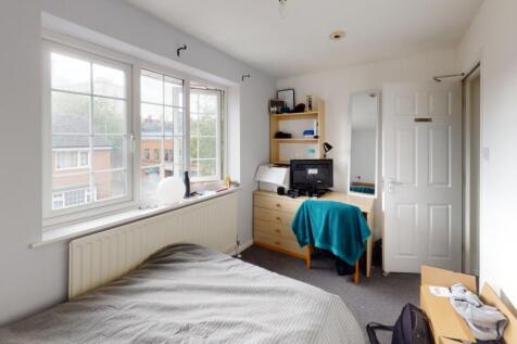 A bright and cozy single bedroom featuring a la...