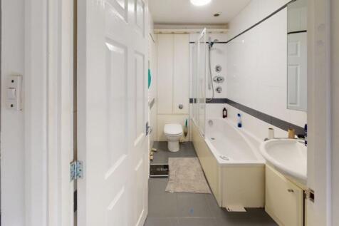 A clean and modern bathroom featuring a large b...