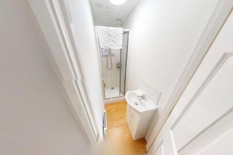 Compact and clean bathroom featuring a modern s...