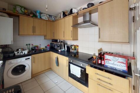 A practical kitchen space featuring wooden cabi...