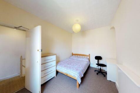A bright and tidy double bedroom featuring a co...