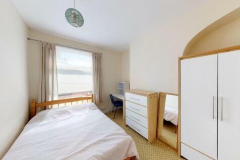 A neat and bright single bedroom featuring a co...