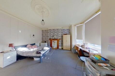 Spacious master bedroom featuring a double bed,...