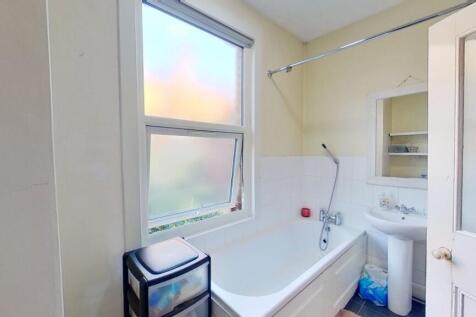 Bright and clean bathroom featuring a full-size...