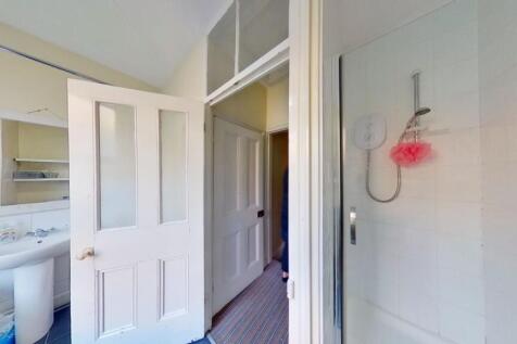 Bright and clean bathroom featuring a modern sh...