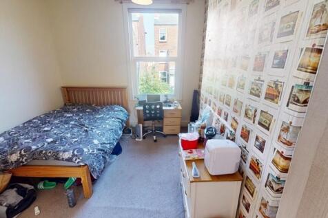 A cozy single bedroom featuring a comfortable s...