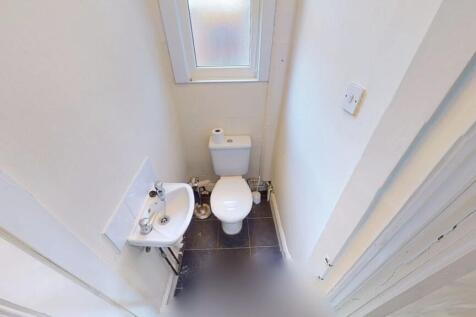 A clean and well-maintained small toilet space ...