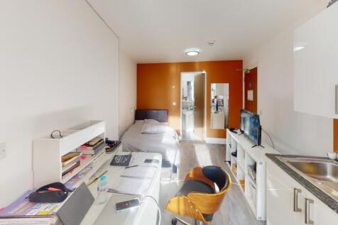 This inviting double bedroom features a cozy at...