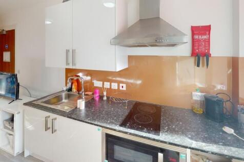 This modern kitchen features sleek cabinetry an...