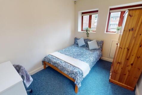 Bright and cozy double bedroom featuring a comf...