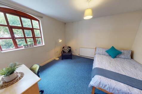 A cozy single bedroom featuring a comfortable s...