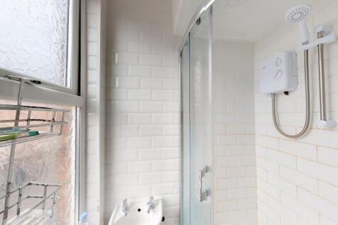 Bright and clean bathroom featuring a modern sh...