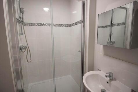 A modern and clean bathroom suite featuring a s...