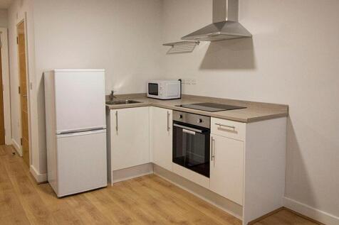 Bright and modern kitchen featuring clean white...
