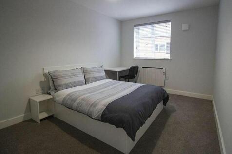 This inviting double bedroom features a comfort...
