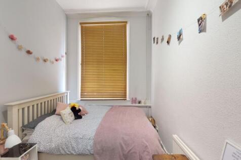 A cozy and tidy single bedroom with a comfortab...